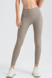 Person wearing beige leggings on a white background