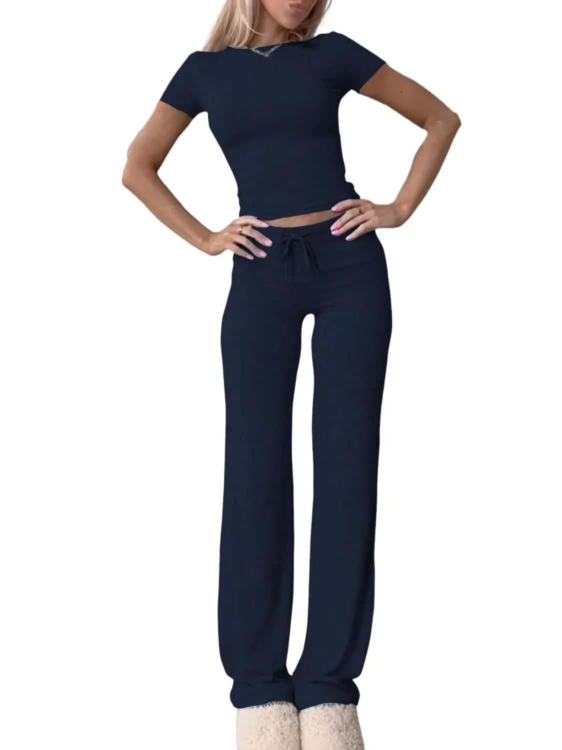 Woman wearing a navy blue outfit on a white background