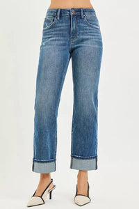 Blue jeans worn by a person on a white background