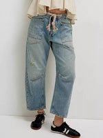 Person wearing blue jeans with a white background