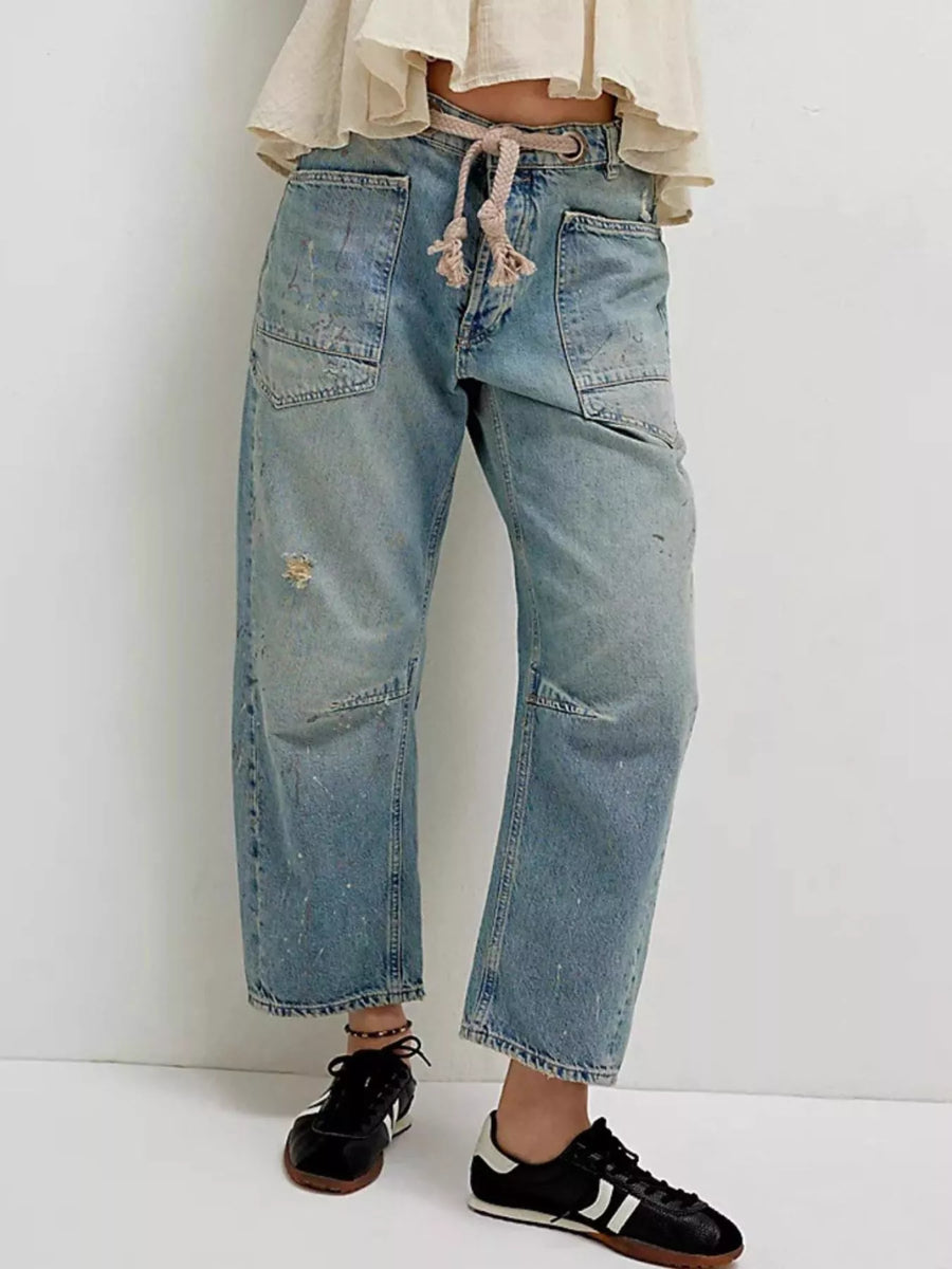 Person wearing blue jeans with a white background