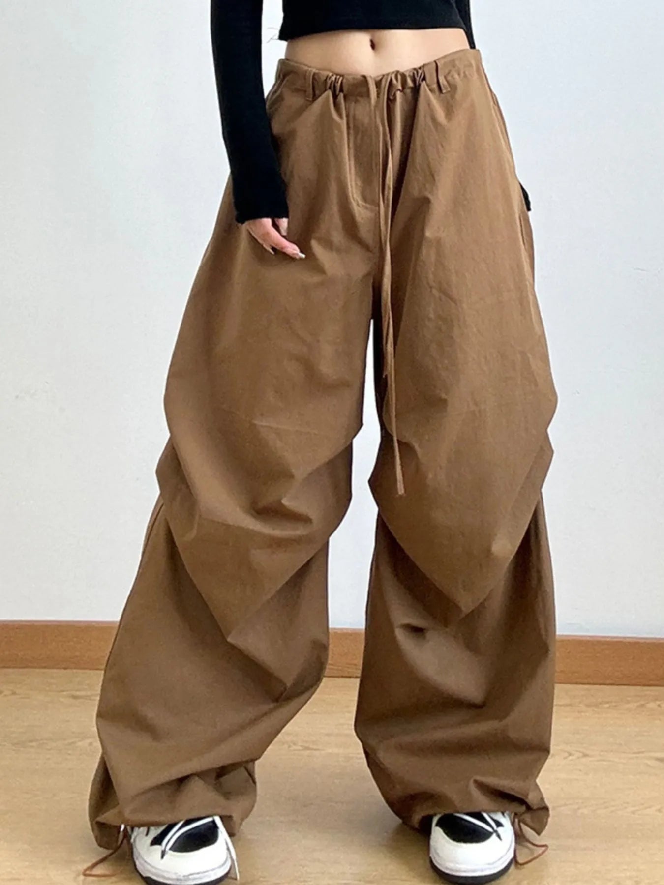 Brown wide-leg pants worn by a person on a plain background
