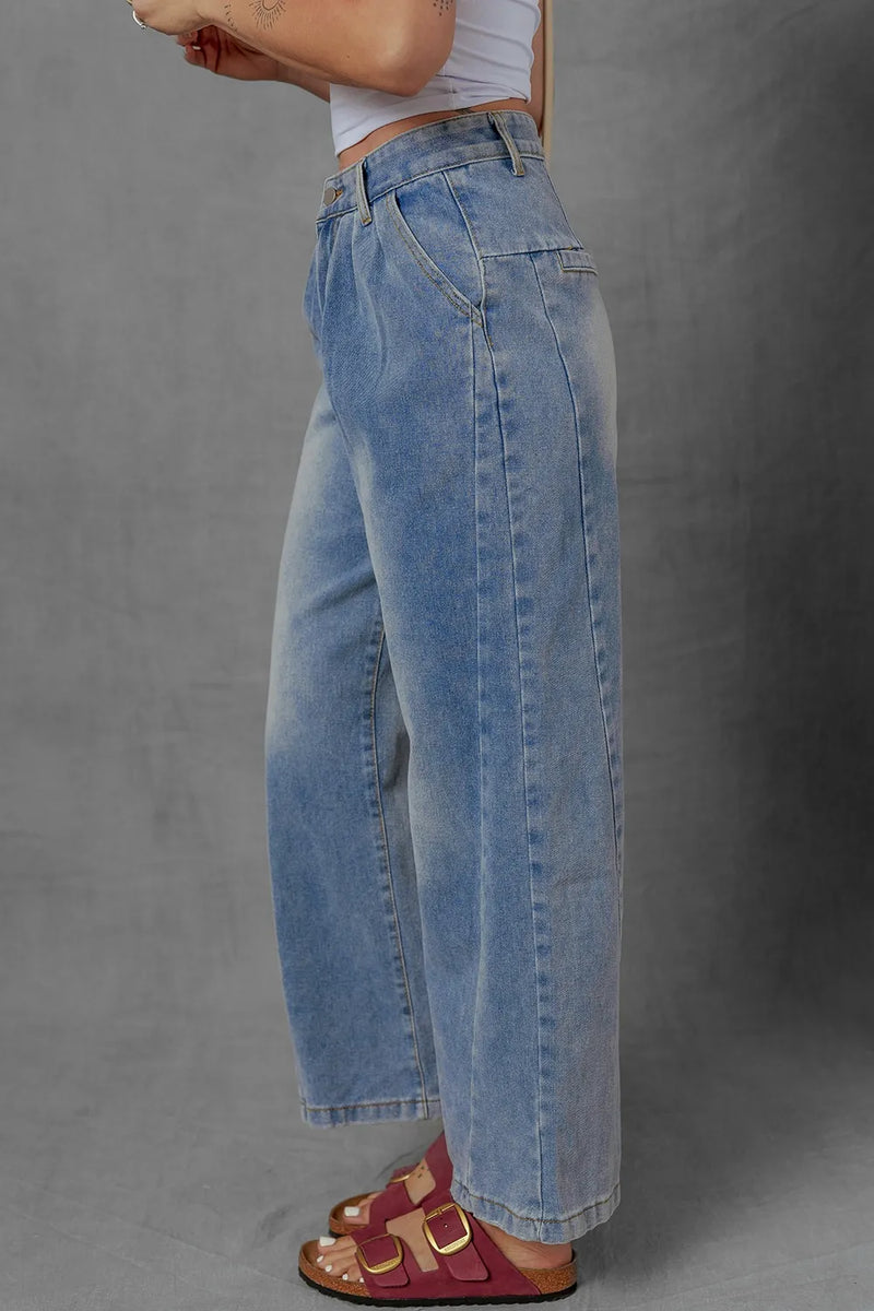 Person wearing blue jeans on a gray background