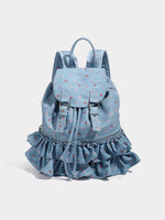 Blue denim backpack with ruffled bottom on a white background