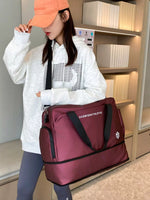Person holding a maroon bag with a brand logo in an indoor setting