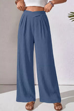 Blue wide-leg pants worn by a person on a neutral background