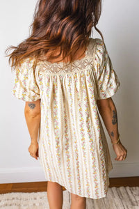 Woman wearing a floral dress with a neutral background