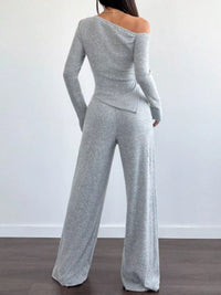 Gray off-shoulder long-sleeve top and wide-leg pants set on a plain background