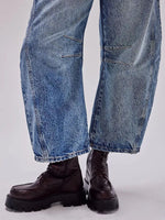 Blue jeans and black boots on a white background