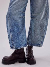 Blue jeans and black boots on a white background