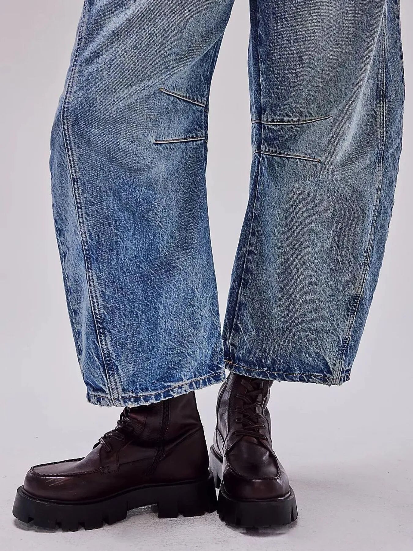 Blue jeans and black boots on a white background