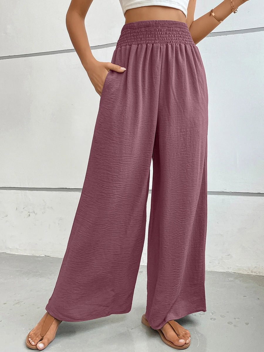 Mauve wide-leg pants worn by a person on a light gray background