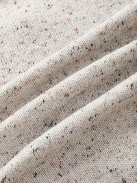 Close-up of textured beige fabric with speckles