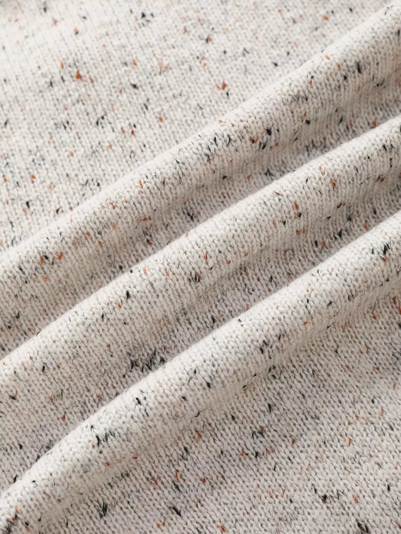 Close-up of textured beige fabric with speckles