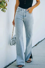 Person wearing light blue flared jeans with a white background