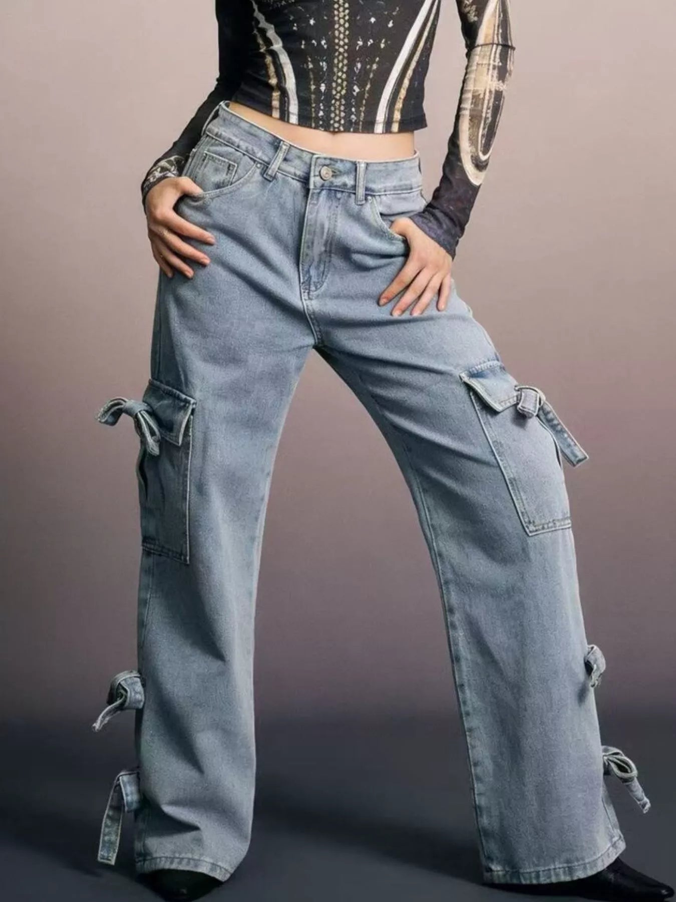 Person wearing blue cargo pants with a plain background