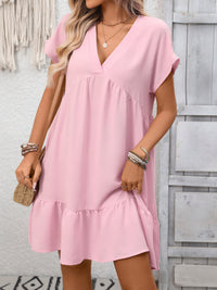 Woman wearing a pink dress with a neutral background