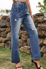 Person wearing blue jeans with a stone wall background