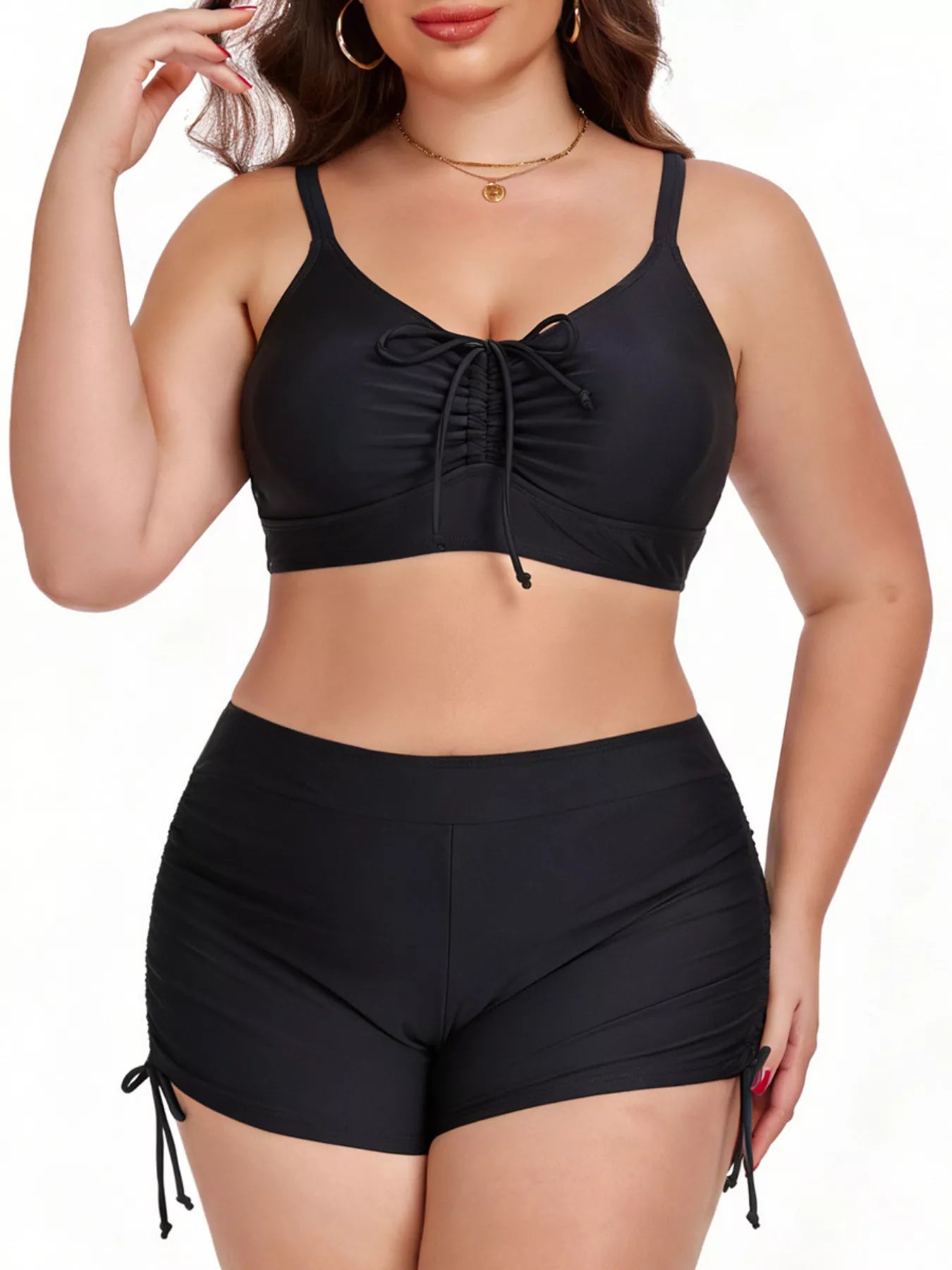Black bikini set with a sports bra top and high-waisted shorts on a white background