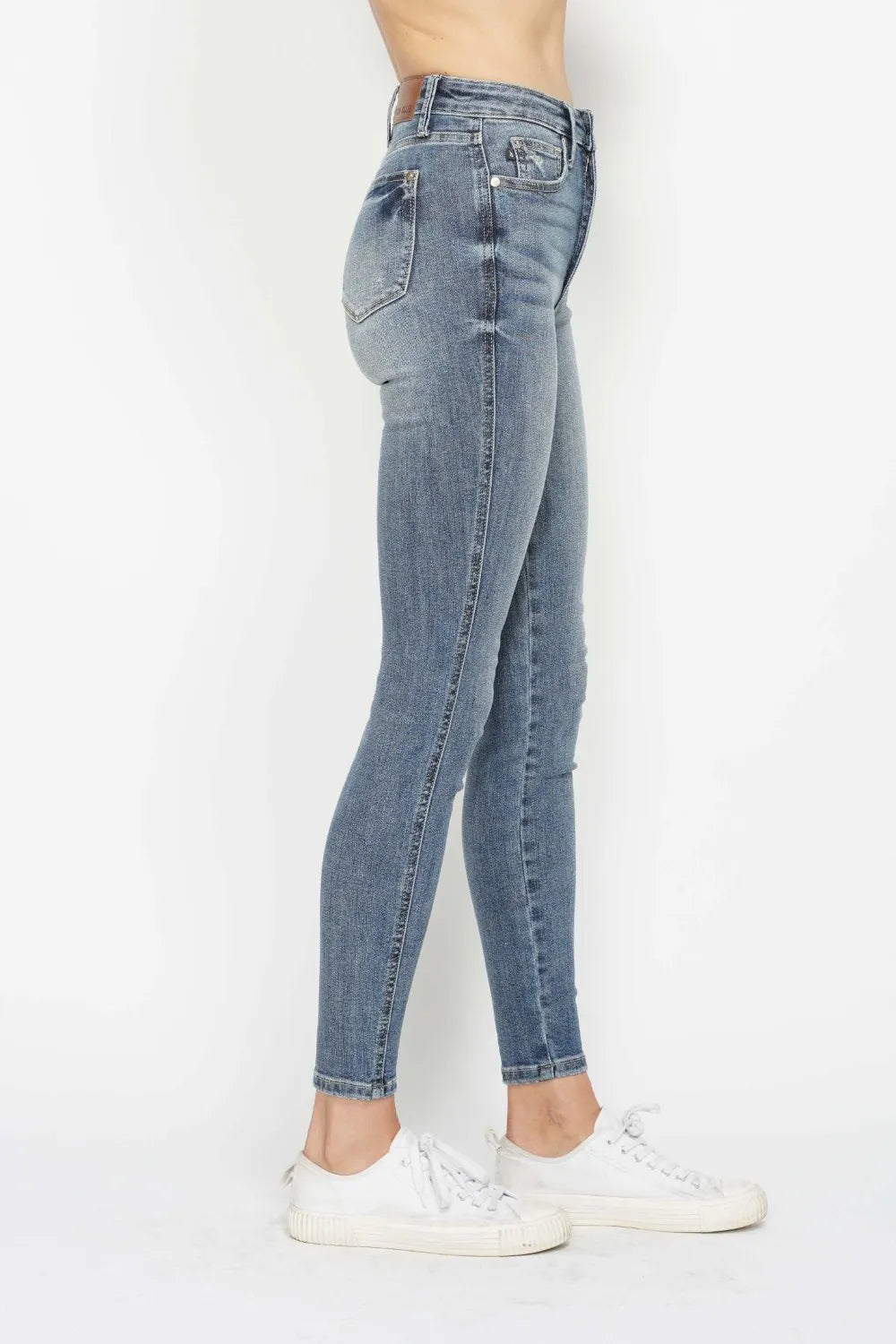 Light blue jeans worn by a person on a white background