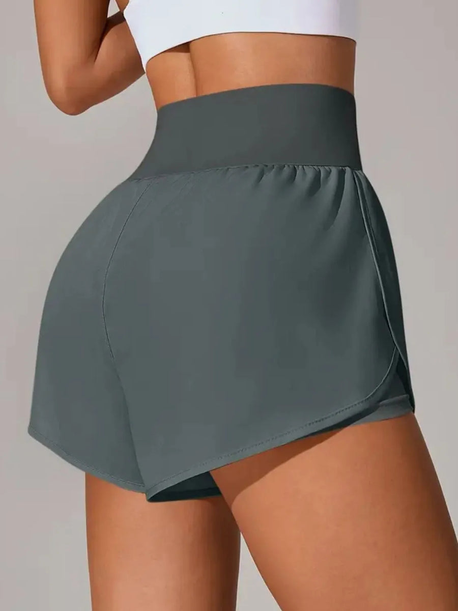 Person wearing a gray athletic skirt on a plain background