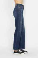 Blue jeans worn by a person on a white background