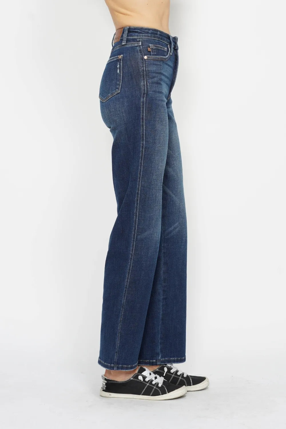 Blue jeans worn by a person on a white background