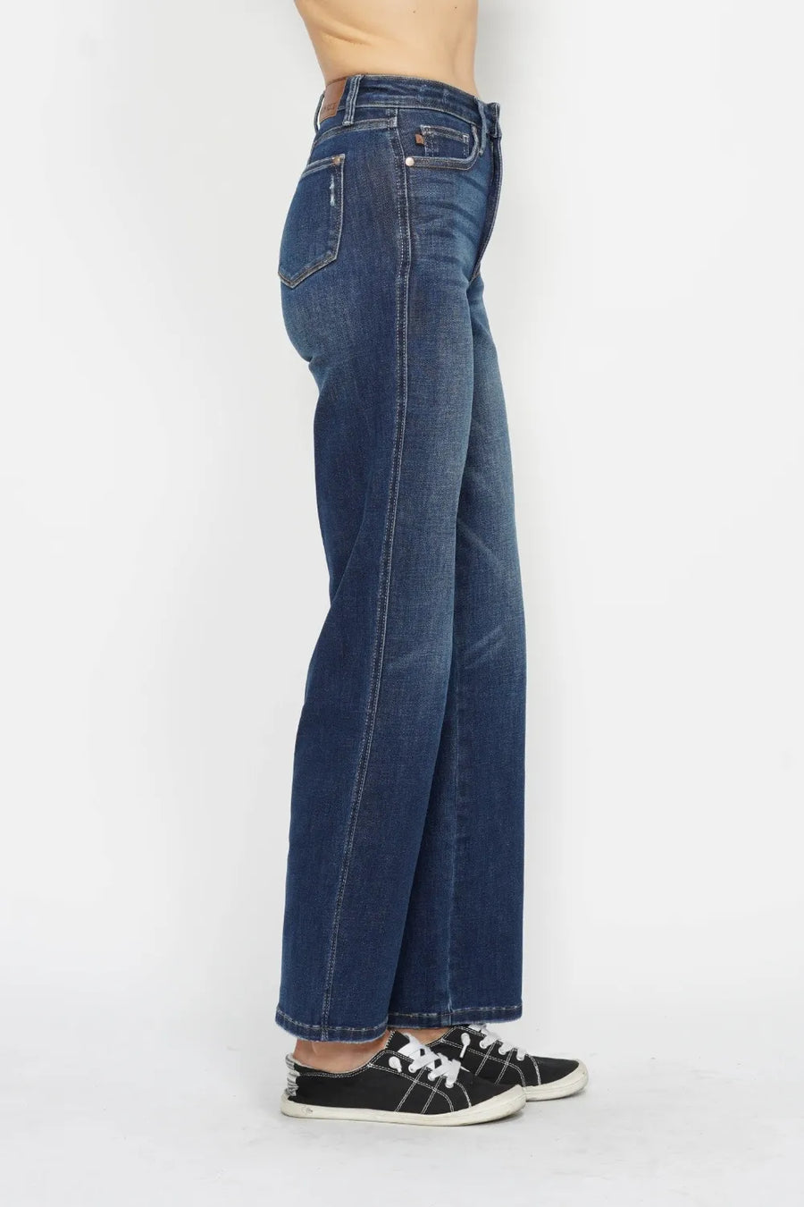 Blue jeans worn by a person on a white background