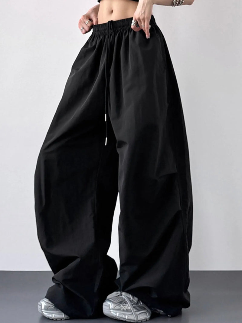 Black wide-leg pants worn by a person on a plain background