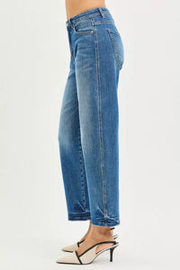 Blue jeans worn by a person on a white background