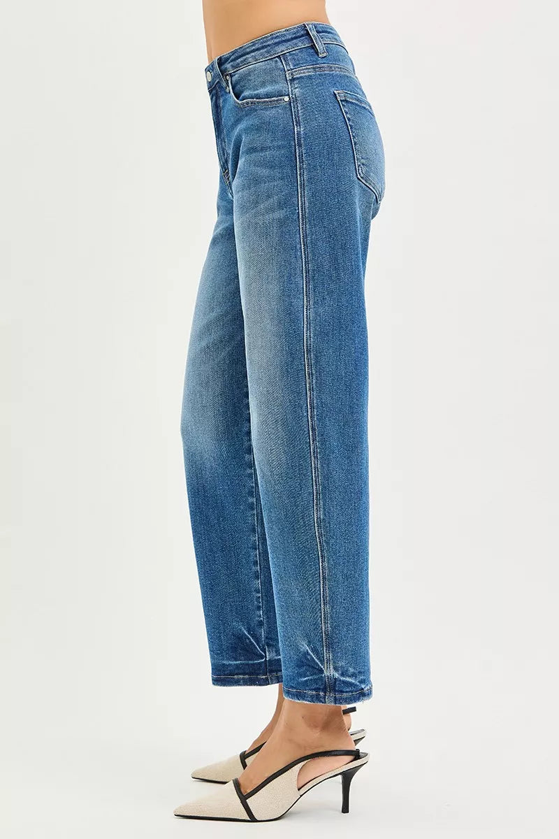 Blue jeans worn by a person on a white background
