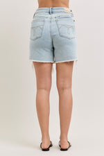 Light blue denim shorts worn by a person on a plain background