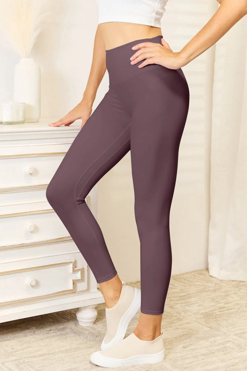 Person wearing purple leggings in a home setting