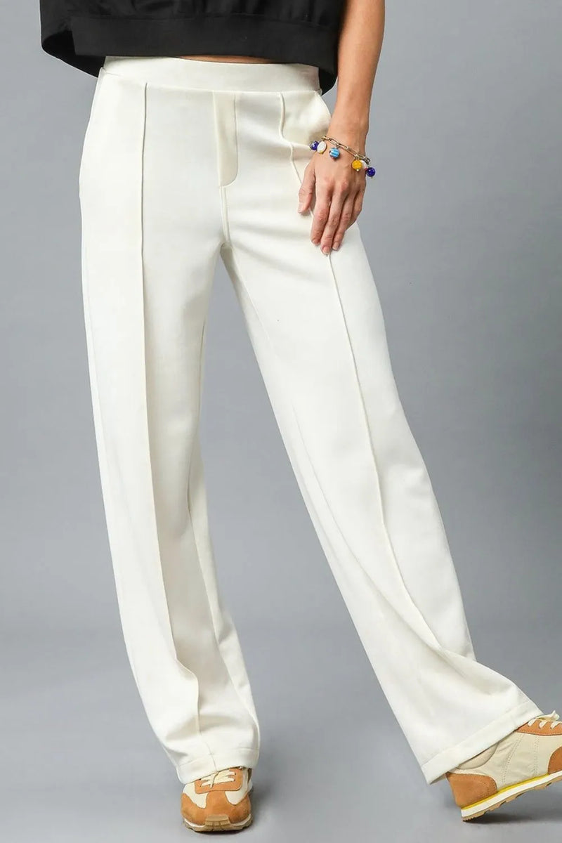 White wide-leg pants worn by a person on a gray background