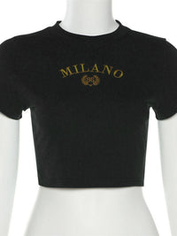 Black crop top with 'MILANO' text on a mannequin against a white background