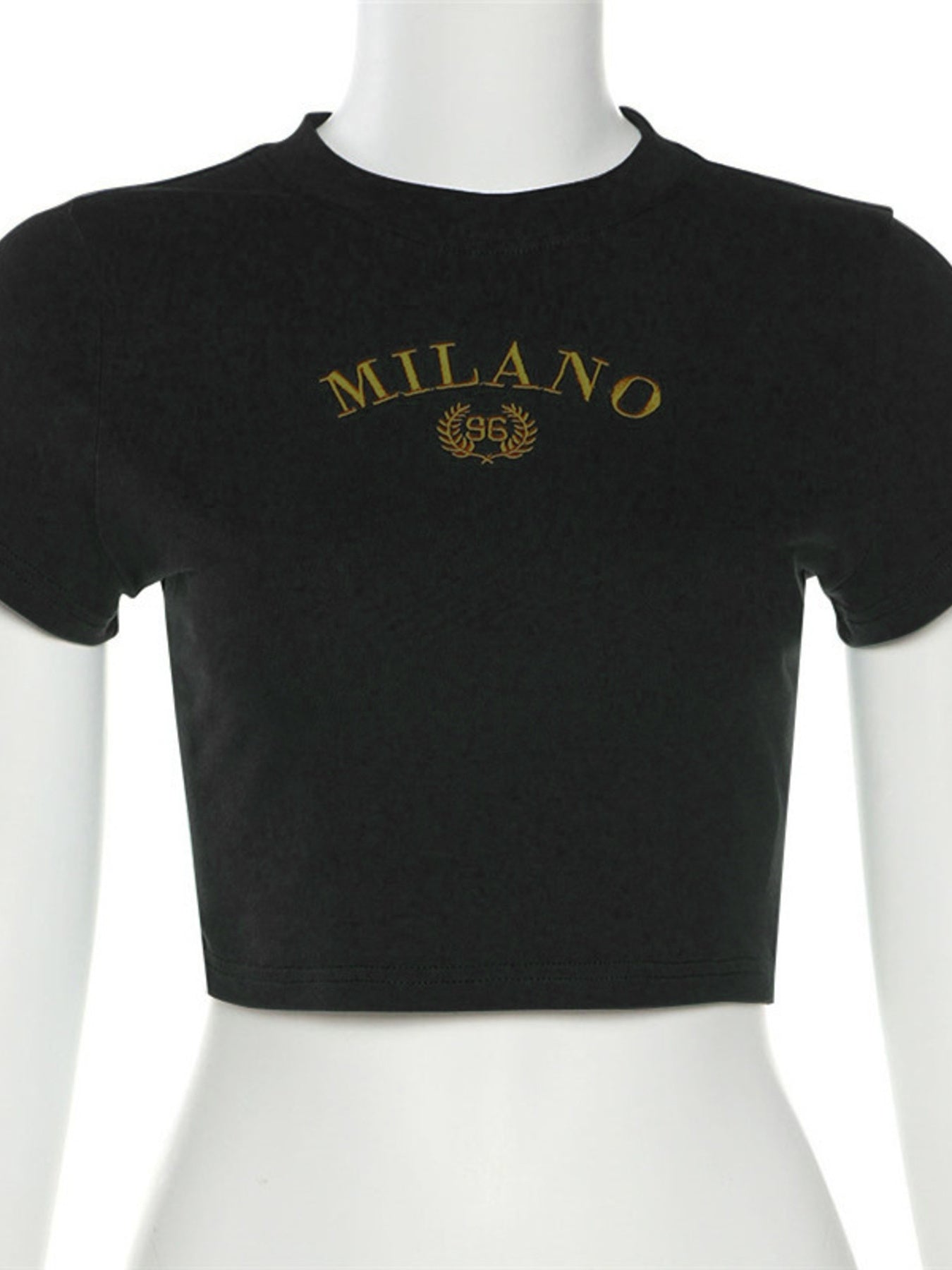 Black crop top with 'MILANO' text on a mannequin against a white background