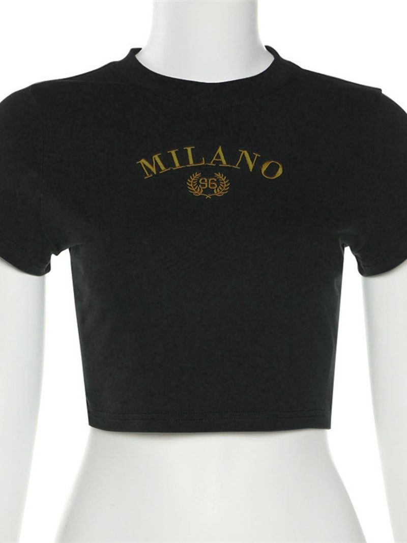 Black crop top with 'MILANO' text on a mannequin against a white background