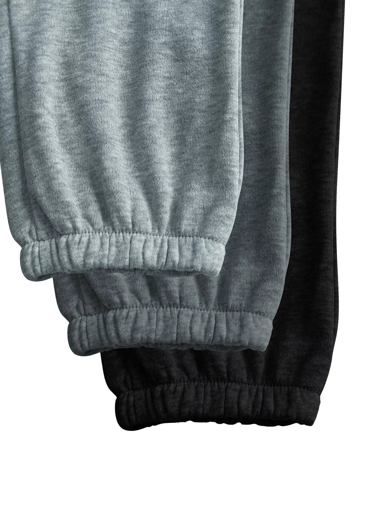 Close-up of gray and black sweatpants with elastic cuffs on a white background