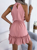 Woman wearing a pink dress with a white background