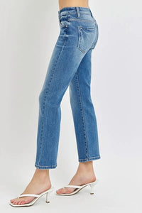 Blue jeans worn by a person on a white background
