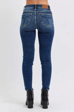 Blue jeans worn by a person on a white background