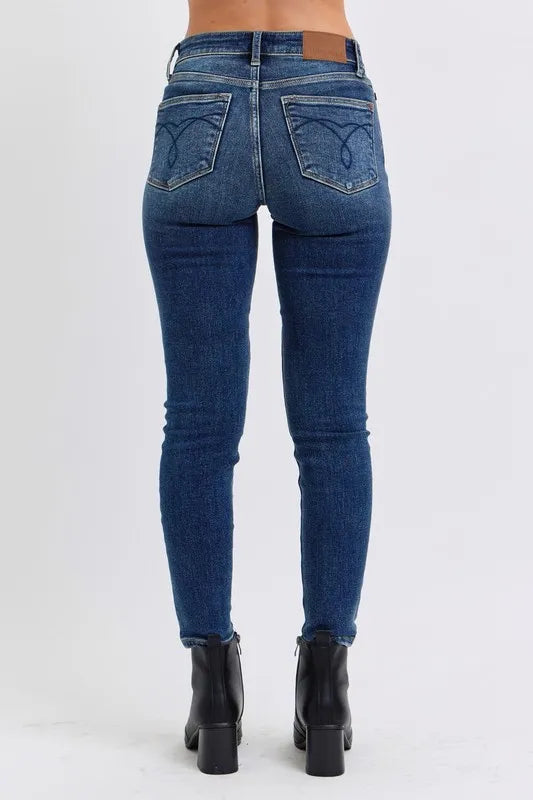 Blue jeans worn by a person on a white background