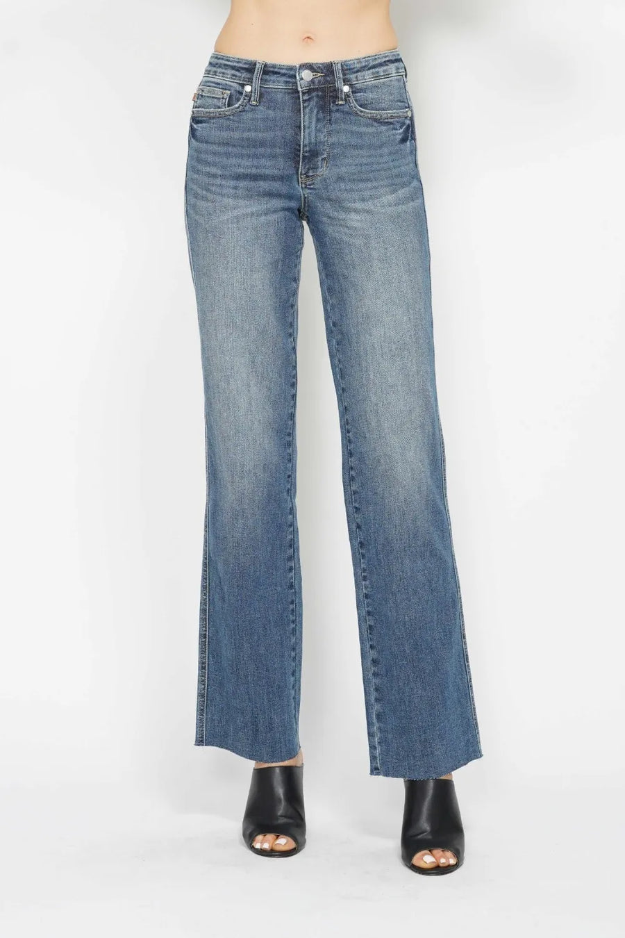 Blue jeans worn by a person on a white background