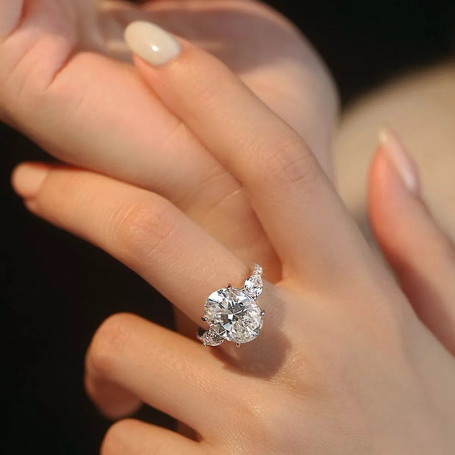 Diamond ring on a finger with a blurred background