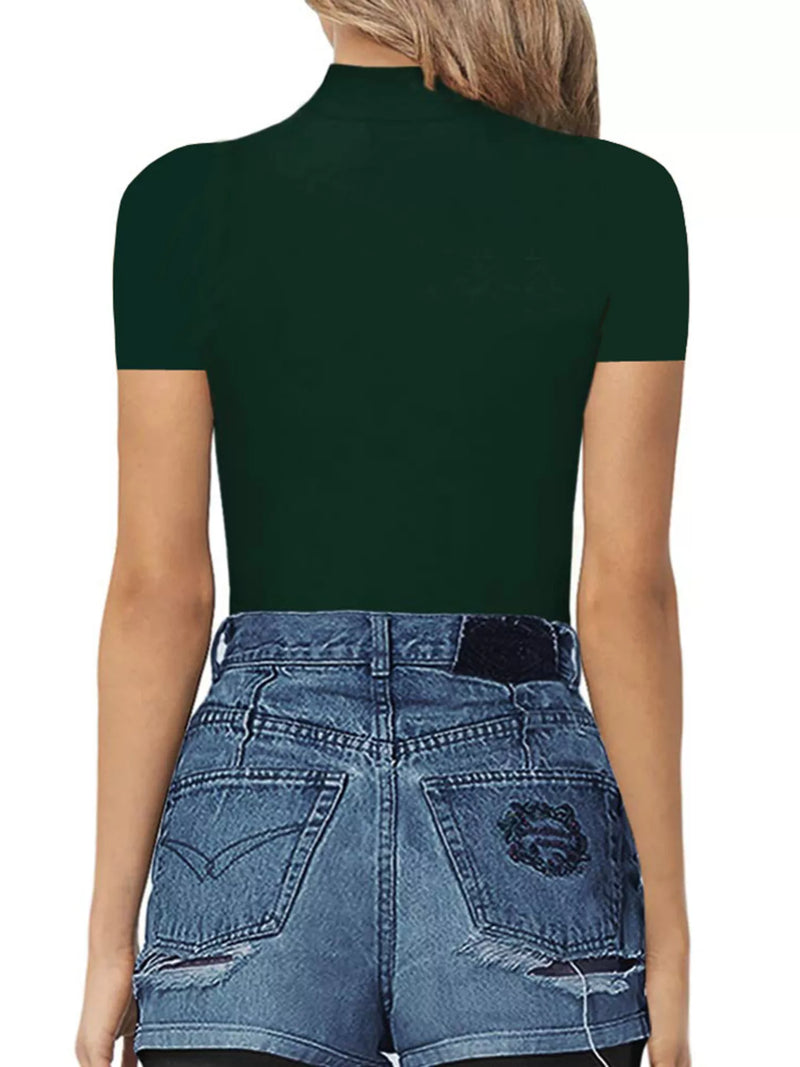 Person wearing a dark green turtleneck and blue jeans on a white background