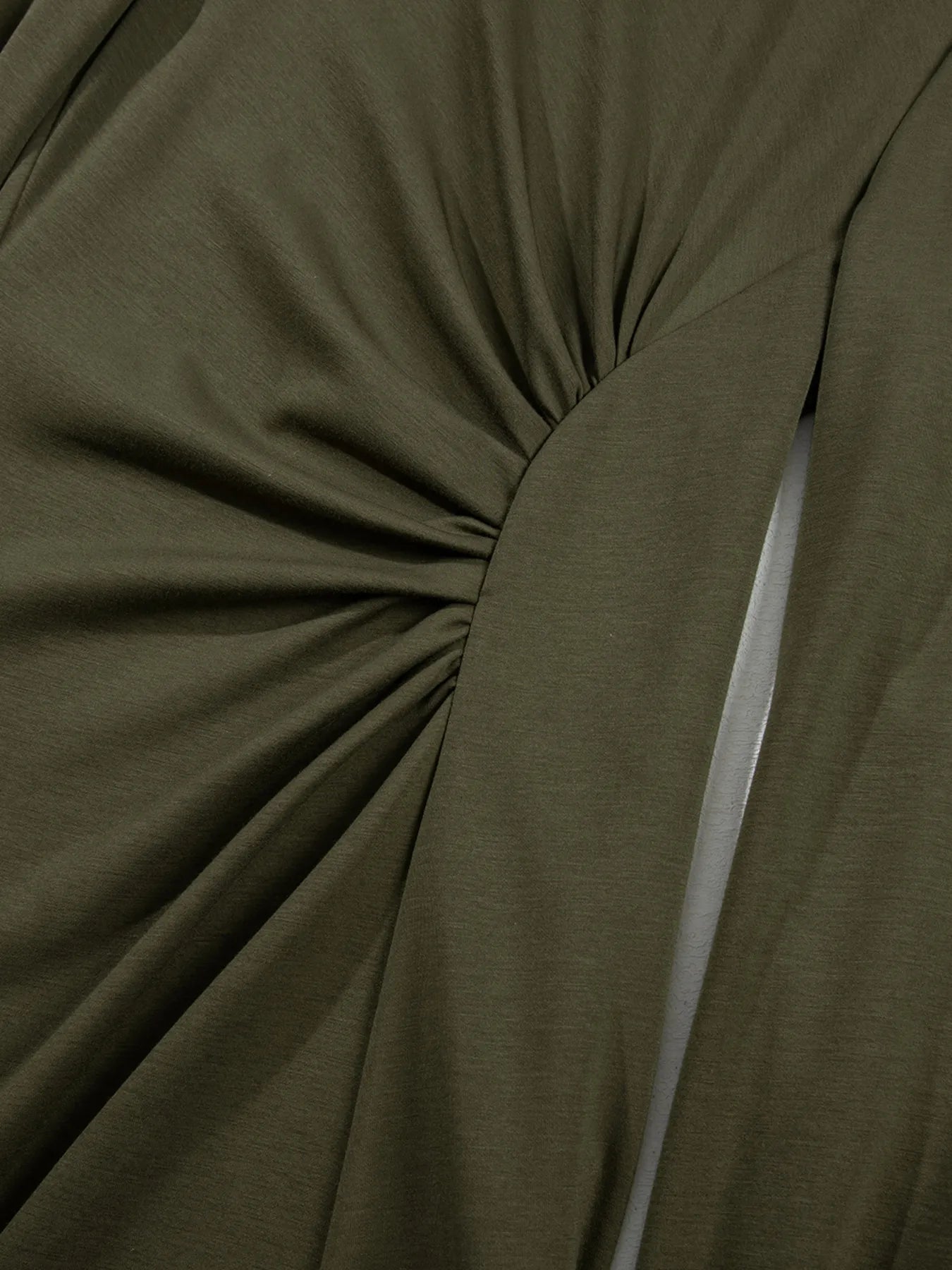 Close-up of olive green fabric with a knot detail