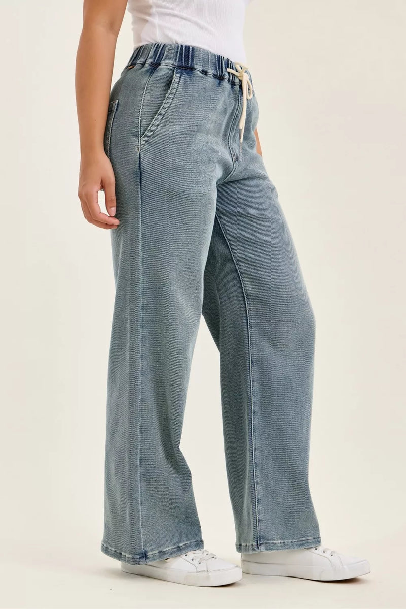 Light blue jeans worn by a person on a white background