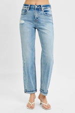 Light blue jeans worn by a person on a white background