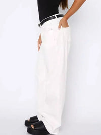 White pants worn by a person on a white background