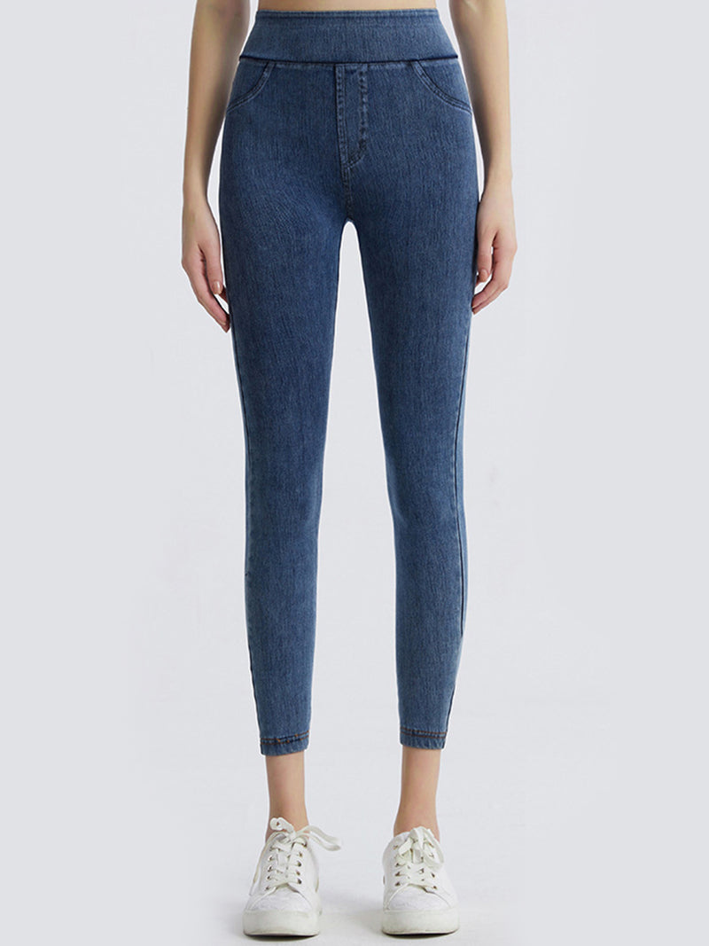 Blue jeans worn by a person on a white background